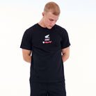 Man wearing a black t-shirt with a logo on a white background