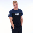 Person wearing a navy t-shirt with a logo on a white background