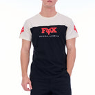 Person wearing a black and white t-shirt with a red logo on a white background