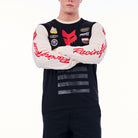 Person wearing a black racing jersey with various logos on a white background
