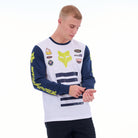 Person wearing a white and blue jersey with various logos on a white background