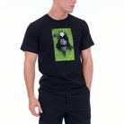 Person wearing a black t-shirt with a green graphic design on a white background