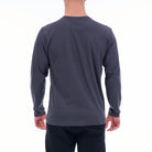 Person wearing a gray long-sleeve shirt on a white background