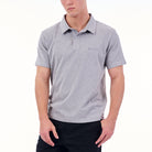 Person wearing a gray polo shirt with a brand logo on a white background