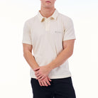 Person wearing a white polo shirt with a brand logo on a white background