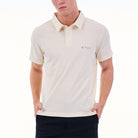Man wearing a white polo shirt with a brand logo on a white background