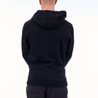 Person wearing a black hoodie from behind on a white background