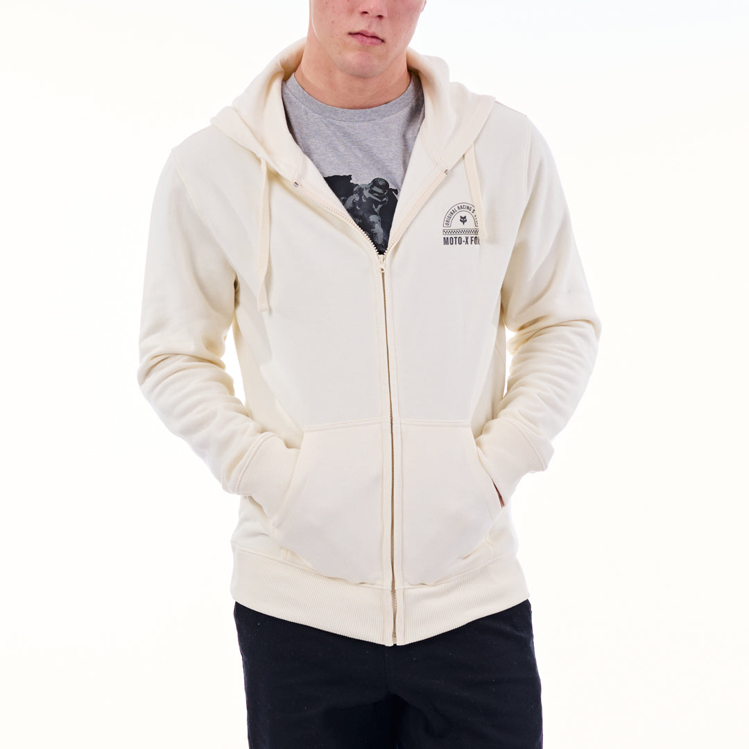 Person wearing a cream hoodie with a logo on a white background