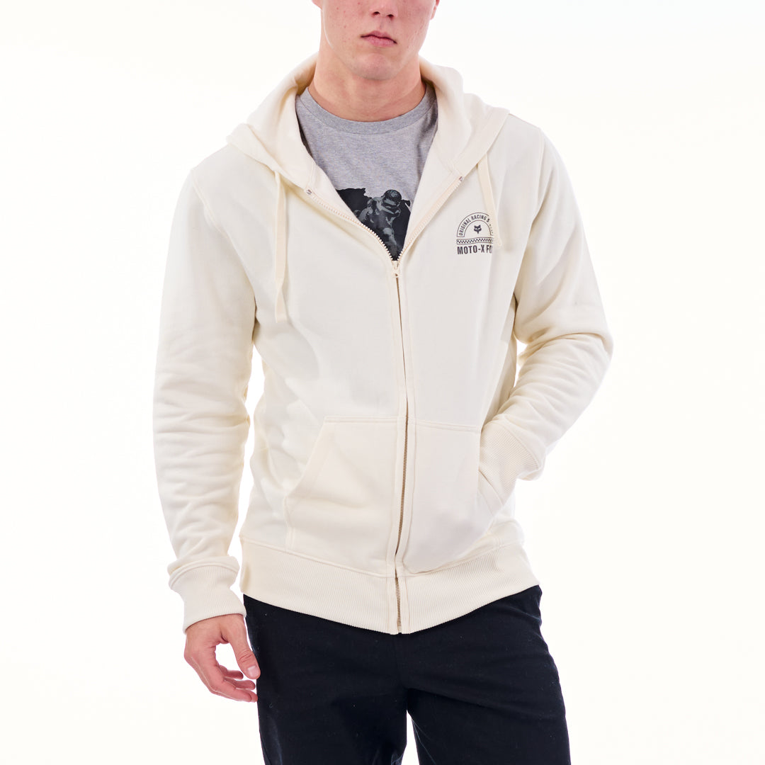 Person wearing a cream hoodie with a logo on a white background