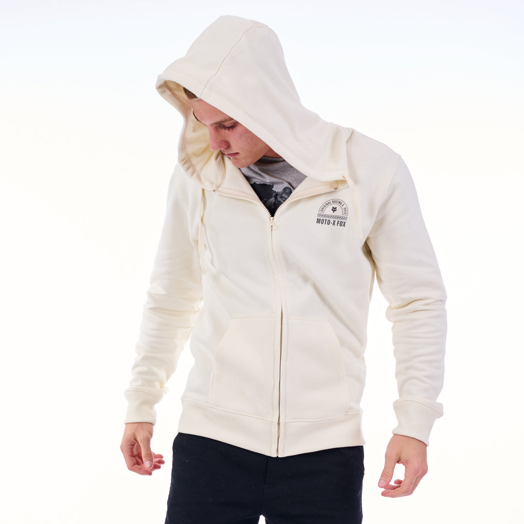Person wearing a cream hoodie with a brand logo on a white background