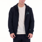 Person wearing a navy blue hoodie with a logo on a white background